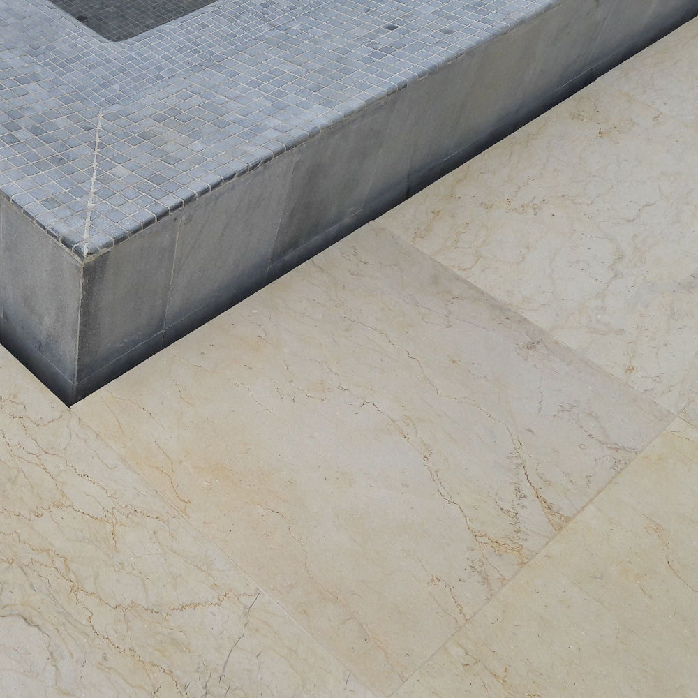 Cape Yamu Villa close-up of a stone floor transition strip between gray and beige tiles.