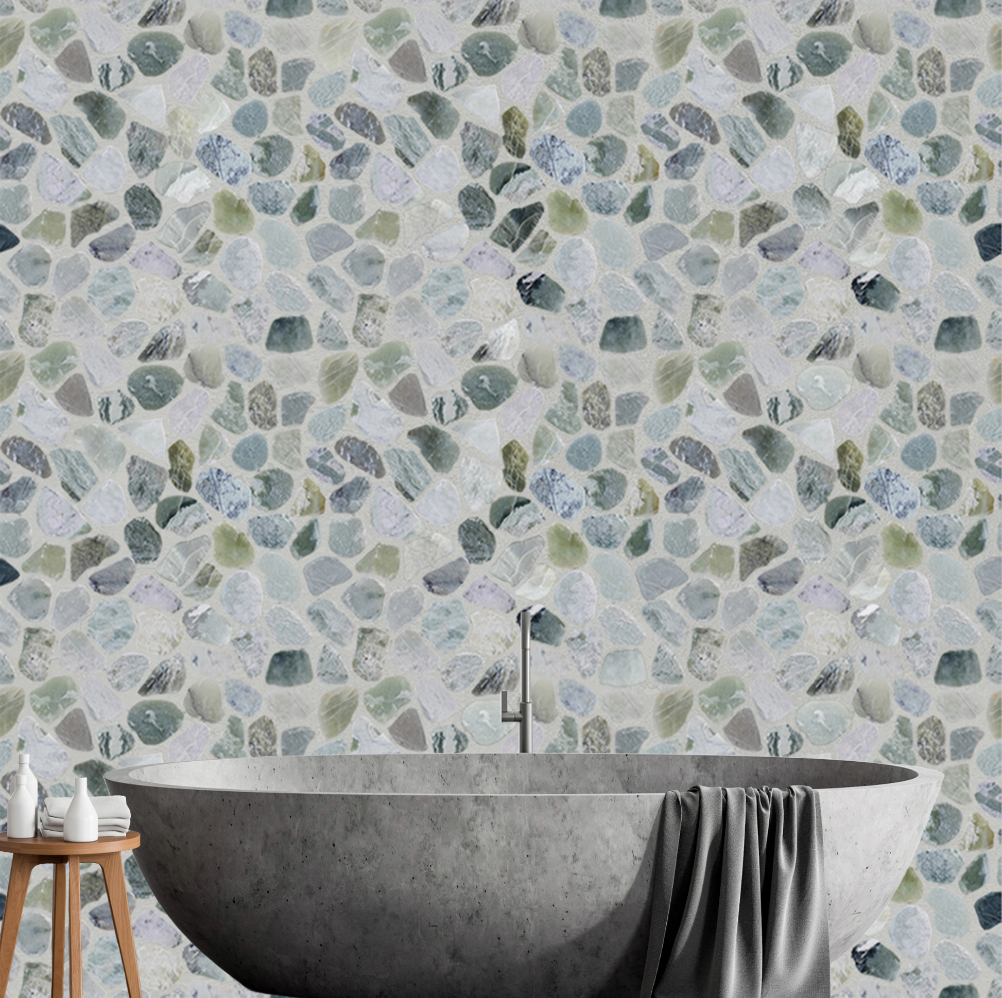 Bathroom with a freestanding bathtub against a wall with a pebble-style tile pattern.