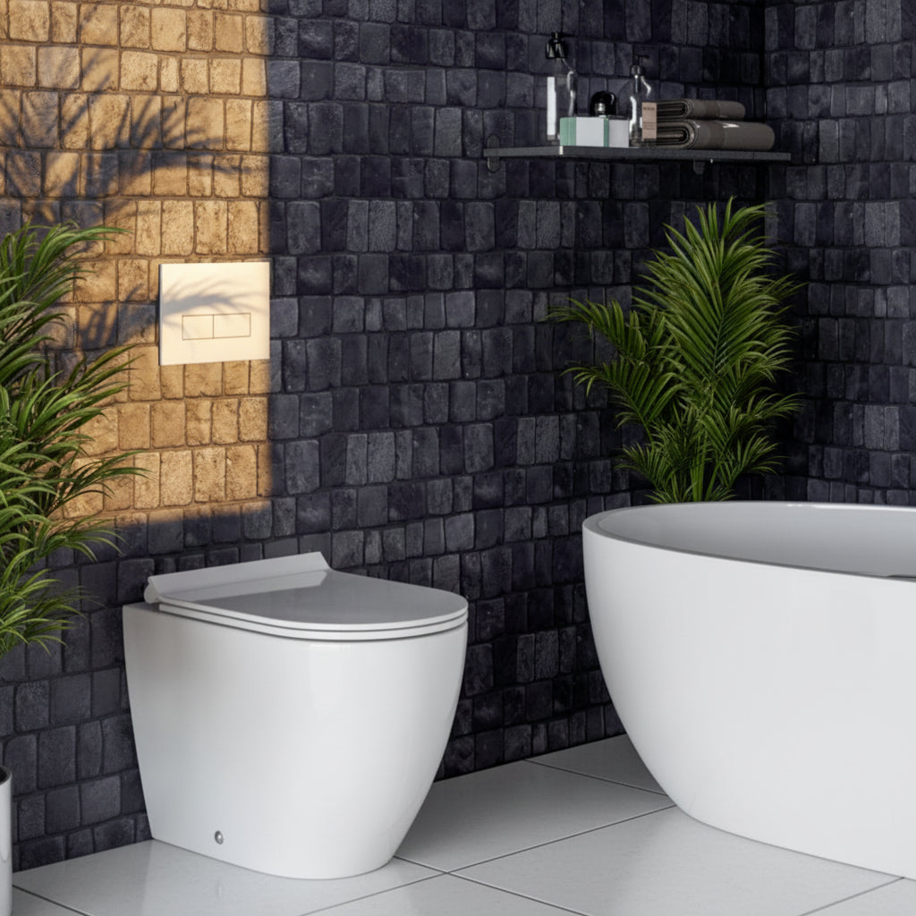 Modern bathroom with black pebble  tiled walls, white toilet, and freestanding bathtub.