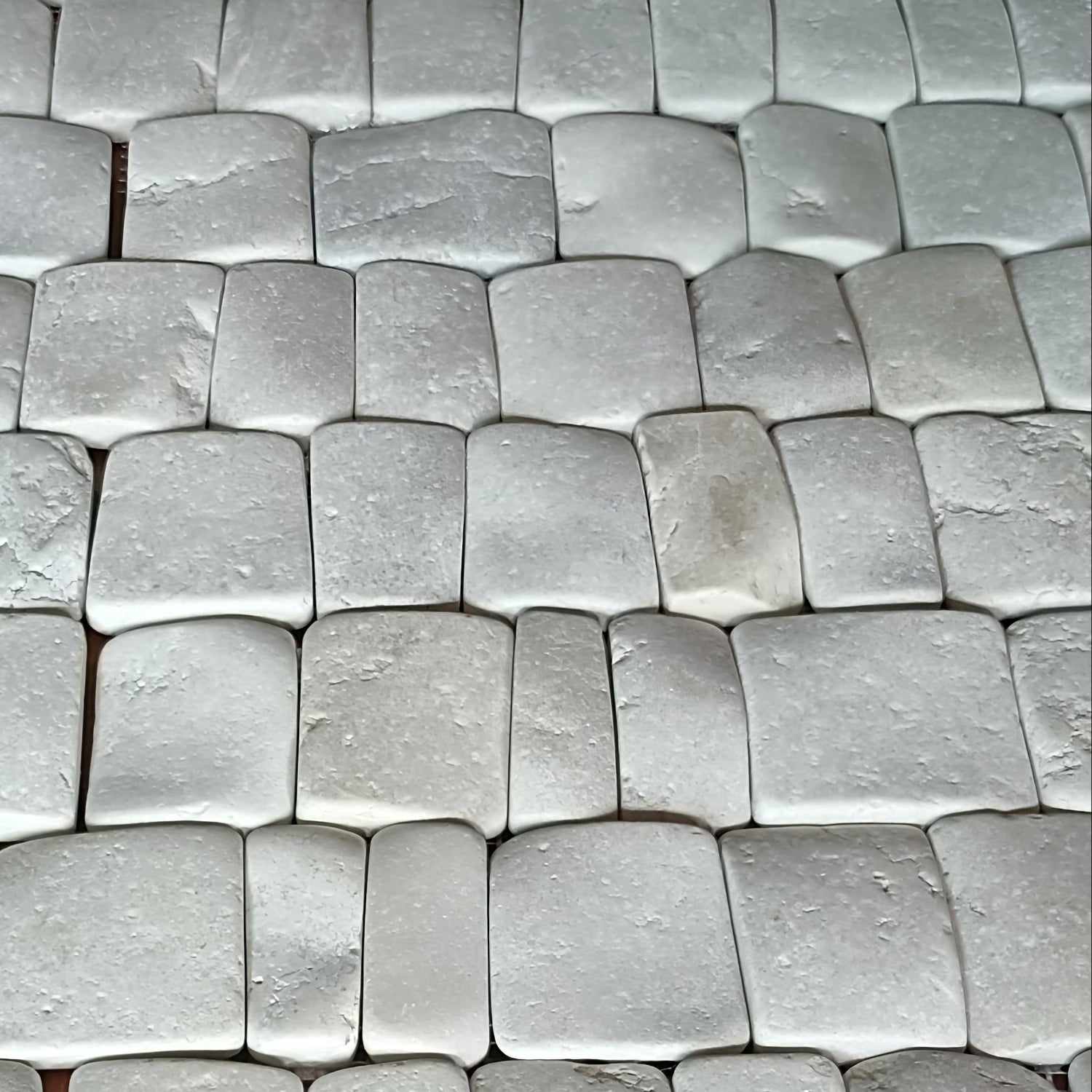 Close-up of Pebble Tile white stone tiles interlocking