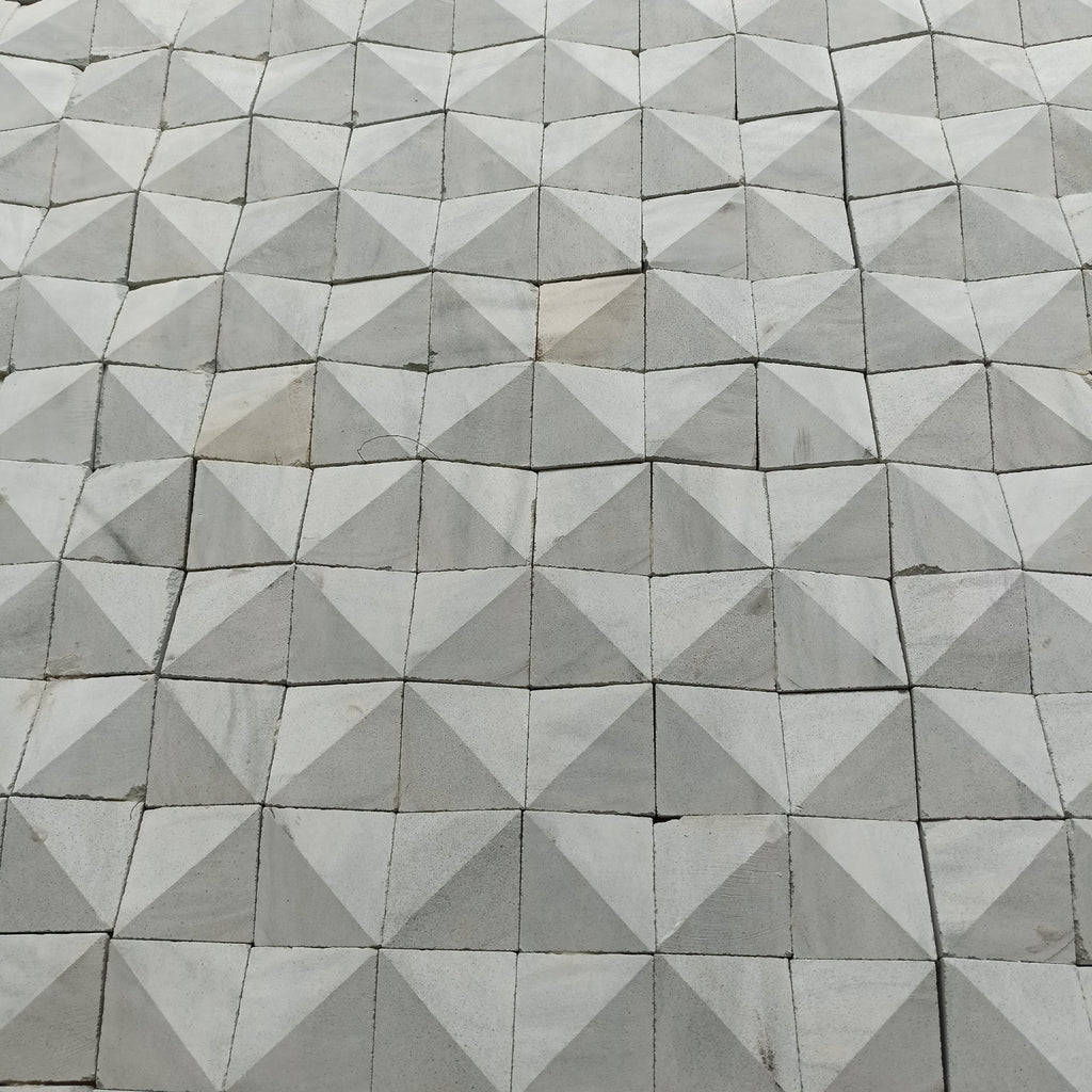 Geometric pattern of gray Zeolite tiles arranged in a diamond formation.