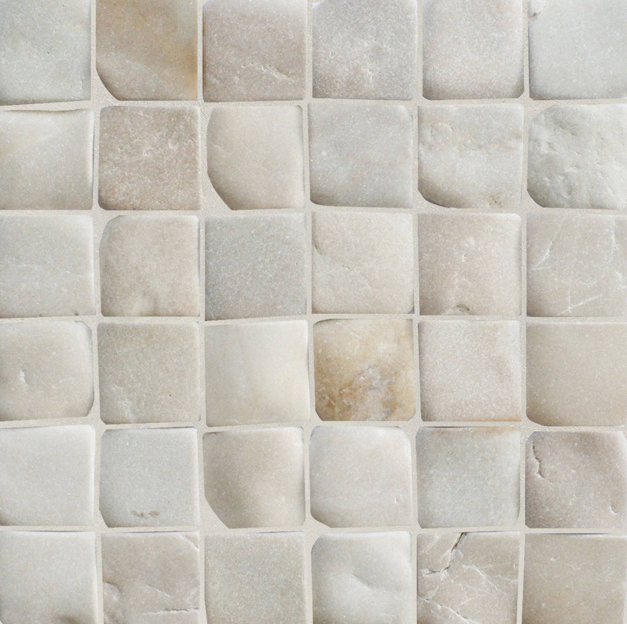 Close-up of a tiled wall with square pebble mosaic tiles in beige.